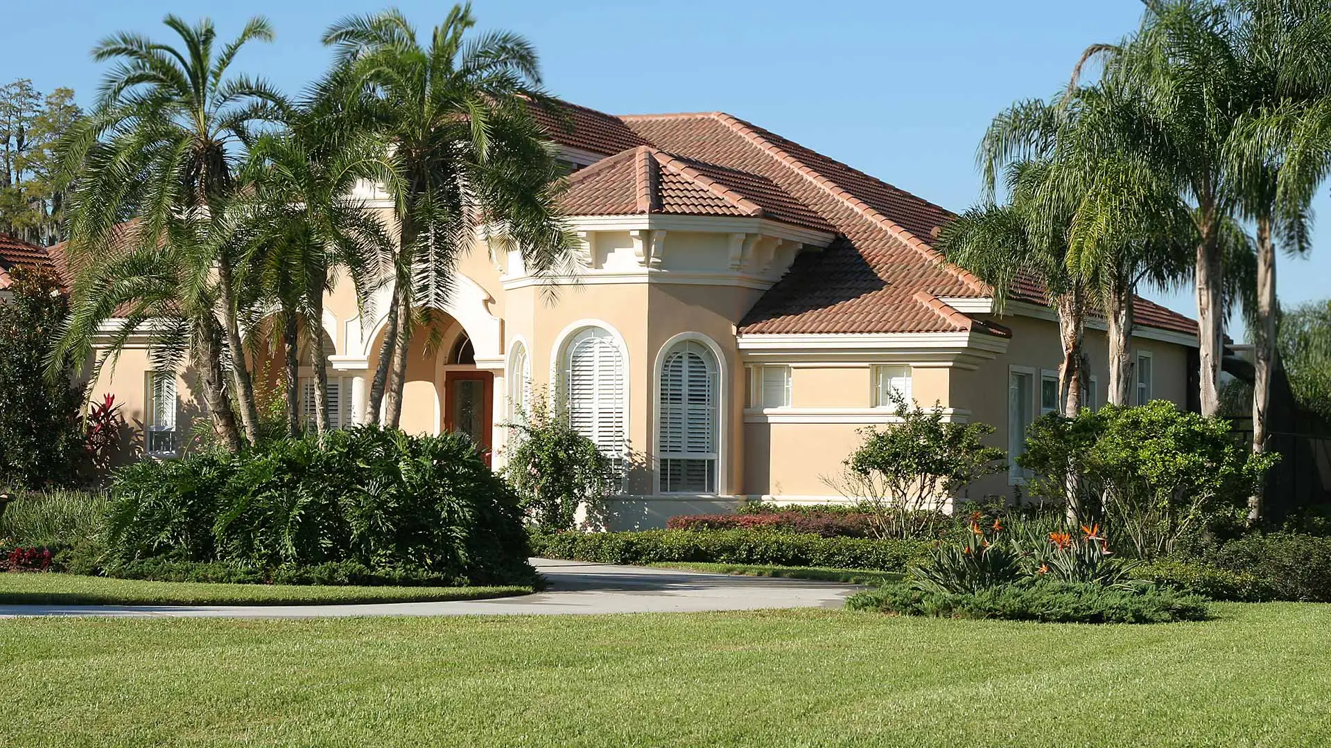 This West Palm Beach, FL home benefits from lawn care and custom landscaping.