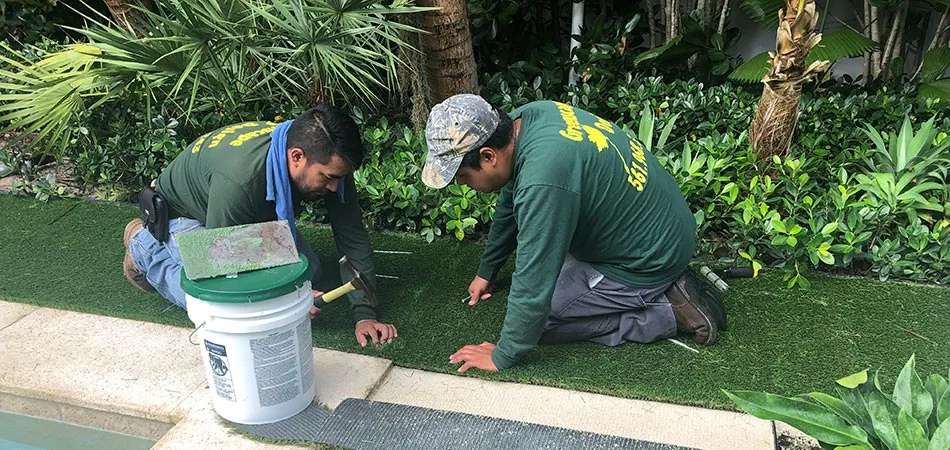 Greenscape Design workers installing artificial turf at this Palm Beach home. 