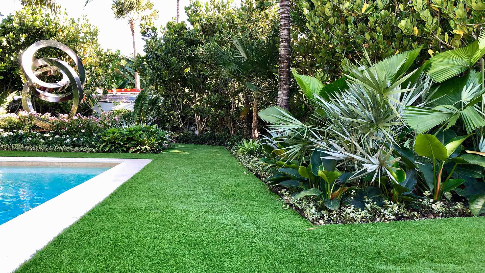 Artificial turf installed for a tropical landscape in Palm Beach, FL.