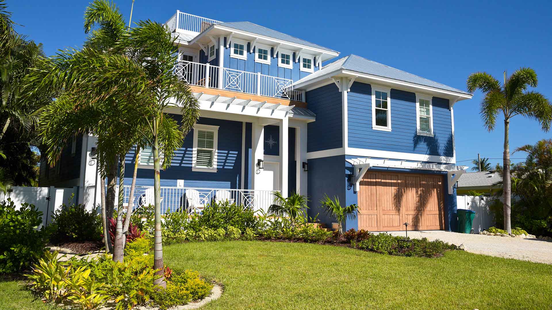 Manalapan, FL beachfront homes benefit from landscaping that uses salt-tolerant plants.
