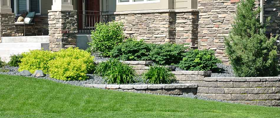 Landscaping walls for this property in Manalapan, FL help bring depth to this landscaping bed.