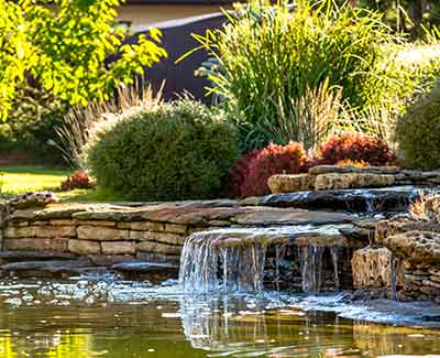 Custom water features such as this one in Manalapan, FL add to your curb appeal.